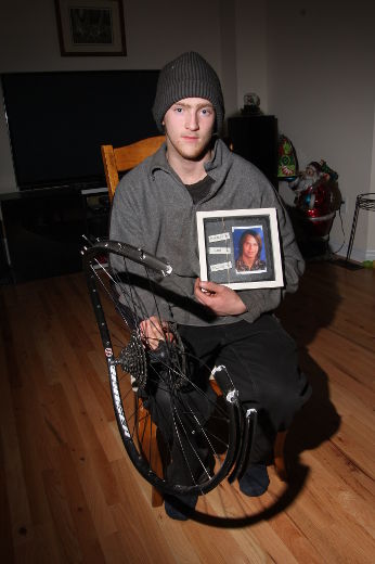 Richard Esch holds to mementos – a photograph of his best friend, Brandon Majewski, and the twisted broken back tire of the bicycle he rode when he was struck by Sharlene Simon. Esch was left a shattered pelvis and permanent injuries. (Tracy McLaughlin/Special to the toronto Sun)