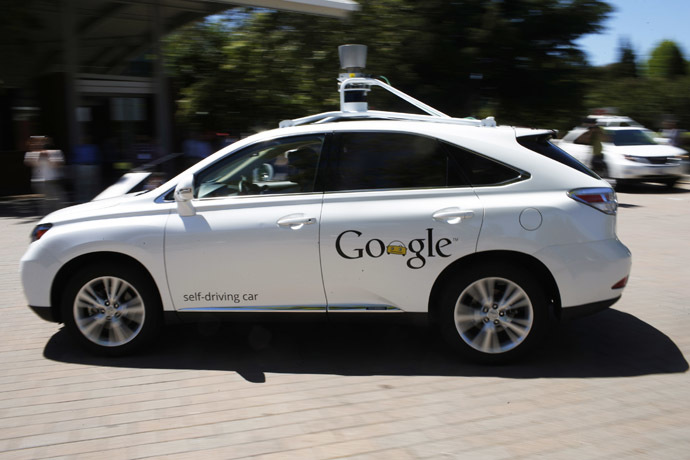 A Google self-driving vehicle drives around the parking lot at the Computer History Museum after a presentation in Mountain View, California