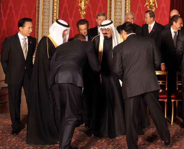 US President Barack Obama (3rd L) bows t