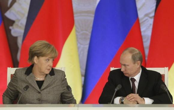 Russian President Putin and German Chancellor Merkel answer journalists' questions during a joint news conference in Moscow's Kremlin