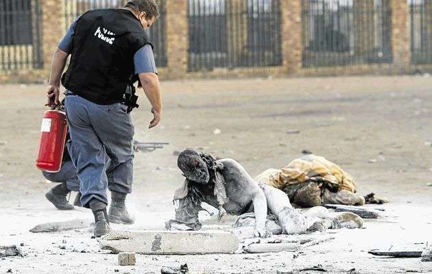 Government worker tries to rescue people who were put on fire.