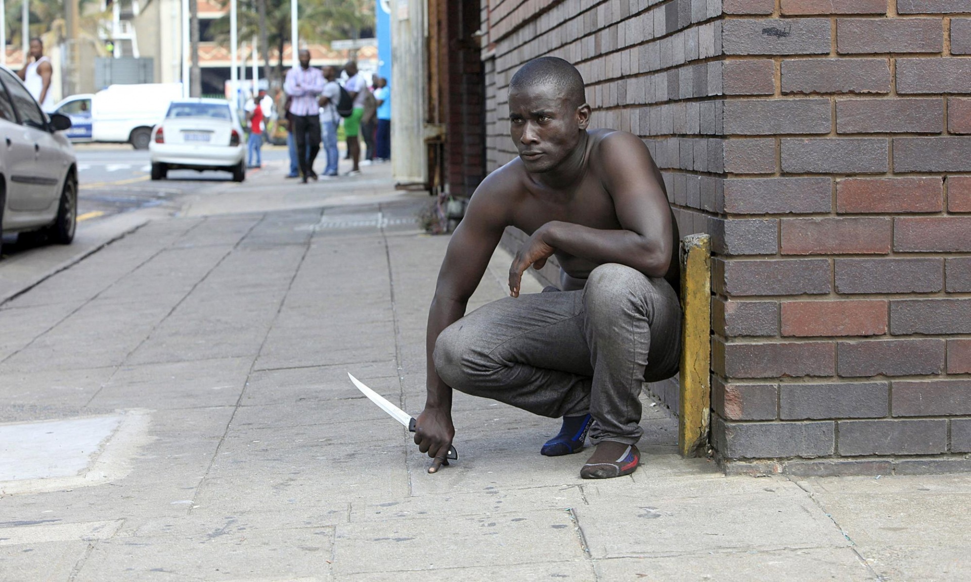 A foreign national holds a knife to protect himself against the Nationals, who are ready to kill him. Photograph: AFP/Getty Images