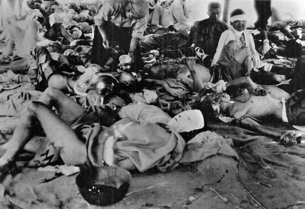 In this picture provided by Japan's Association of the Photographers of the Atomic (Bomb) Destruction of Hiroshima, nuclear bomb victims are sheltered at the Hiroshima Second Military Hospital's tent relief center at the banks of the Ota River in Hiroshima, Japan, 1,150-meters (1,258-yards) from the epicenter on Aug. 7, 1945, one day after the world's first nuclear bombing by the United States. (AP Photo/The Association of the Photographers of the Atomic (Bomb) Destruction of Hiroshima, Yotsugi Kawahara, HO)