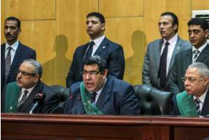 Egyptian judge Shabaan el-Shamy (centre) reads out the verdict sentencing deposed Islamist president