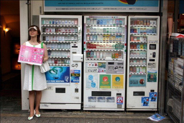 Image Source: Google Image - Cigarette vending machines in Tokyo, with a woman promoting the products