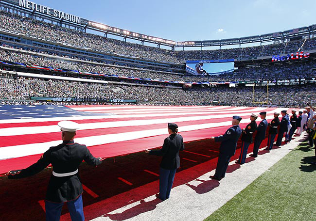 EAST RUTHERFORD, NJ - SEPTEMBER 9: Members of the military hold a large American flag over the field before the start of a game between the Buffalo Bills and New York Jets at MetLife Stadium on September 9, 2012 in East Rutherford, New Jersey. (Photo by Rich Schultz /Getty Images)