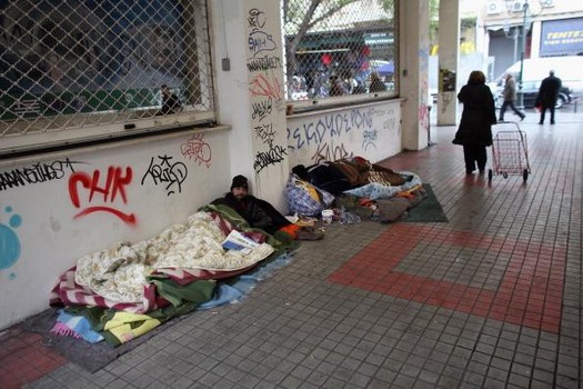 ATHENS, GREECE - FEBRUARY 16:  Homeless men sleep rough beneath a graffiti-covered wall in a train station on February 16, 2012 in Athens, Greece. Following a meeting yesterday, finance ministers across the Eurozone are calling for greater scrutiny and oversight of Greece's proposed budget cuts in order to approve the latest 130 billion euro bailout package. The package, which is anticipated to be finalised on February 20, 2012, is essential for Greece to avoid defaulting on a 14.5 billion euro bond it is due to repay in mid-March.  (Photo by Oli Scarff/Getty Images)