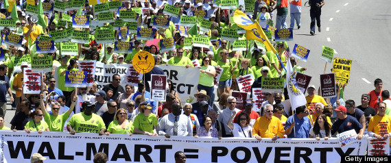 Thousands of protesters march during the country's largest anti Walmart rally in Chinatown on June 30, 2012, in Los Angeles, California. Opponents of Walmart claim that the world's largest private company with 1.4 million employees in the US abuses the rights of its workers to unionize, pays low wages and provides inadequate health benefits.  AFP PHOTO/JOE KLAMAR        (Photo credit should read JOE KLAMAR/AFP/GettyImages)