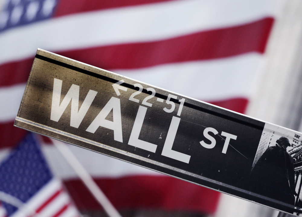 FILE - This Aug. 9, 2011 file photo shows a Wall Street street sign near the New York Stock Exchange, in New York. U.S. stock indexes are opening mostly higher Monday, Dec. 22, 2014, as the market builds on its big gains from last week. (AP Photo/Mark Lennihan, File) ORG XMIT: NYBZ125