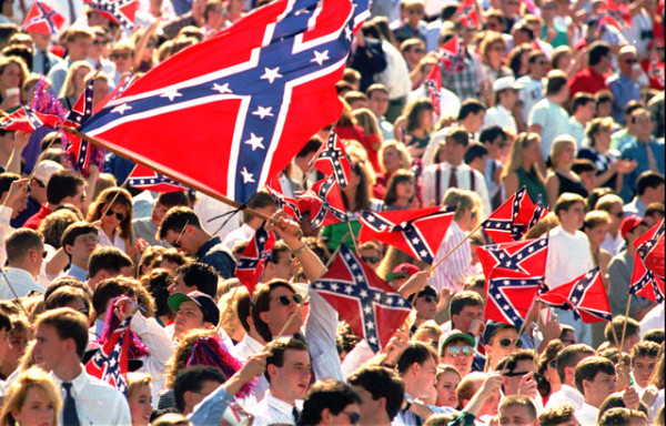 **FILE**The University of Mississippi has been disassociated for several years from the "Rebel" flag, shown being waved by Ole Miss fans at a 1995 football game at Oxford, Miss.. However, efforts last year by coaches to help change the state flag which bears the symbol within its borders failed in a statewide vote. Little if any fallout over the vote has affected the school's recruiting efforts among black athletes. (AP Photo/Tannen Maury, File)