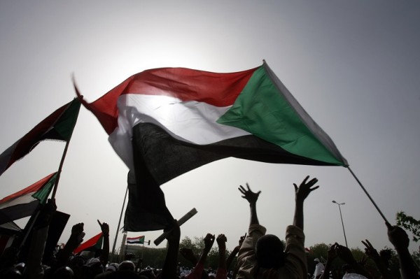 Sudanese wave national flags as they gather outside the Defence Ministry in the capital Khartoum on April 20, 2012 to celebrate retaking the oil town of Heglig from South Sudanese forces. Border clashes between Sudan and South Sudan escalated last week with waves of air strikes hitting the South, and Juba seizing the north's Heglig oil hub on April 10. AFP PHOTO/ASHRAF SHAZLY (Photo credit should read ASHRAF SHAZLY/AFP/Getty Images)