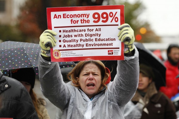 Occupy K Street demonstrators protest on a street in Washington October 29, 2011, calling on the wealthiest 1 percent, including Wall Street speculators, hedge fund managers and bankers to pay their fair share to contribute to the needs of the 99 percent who paid for their bailouts. REUTERS/Jose Luis Magana (UNITED STATES - Tags: CIVIL UNREST BUSINESS POLITICS)