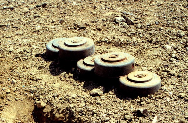 970710-N-2240H-004 Five M15 anti-tank land mines are stacked for destruction at a demolition site on Naval Station Guantanamo Bay, Cuba, in this July 10, 1997, file photo. Anti-personnel and anti-tank land mines on the U.S. side of the fence separating Communist Cuba and the U.S. Naval Base at Guantanamo Bay are being removed in accordance with the Presidential Order of May 16, 1996. Approximately 50,000 land mines were placed in the buffer zone between Communist Cuba and Guantanamo Bay beginning in 1961 as a result of the Cold War. The land mines are being replaced by motion and sound sensors to detect any incursion onto the base. DoD photo by Petty Officer 1st Class Ronald L. Heppner, U.S. Navy.