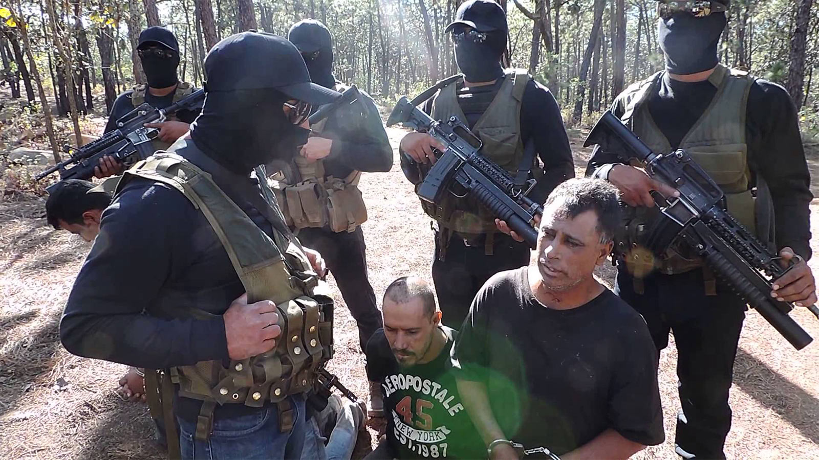 Members of the Jalisco New Generation cartel (CJNG) record themselves with prisoners from a rival cartel.