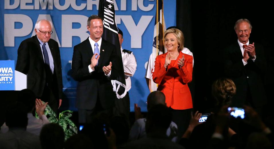 Democratic presidential candidates, from left, Bernie Sanders, Martin O'Malley, Hillary Rodham Clinton and Lincoln Chafee stand on stage during the Iowa Democratic Party's Hall of Fame Dinner, Friday, July 17, 2015, in Cedar Rapids, Iowa. (AP Photo/Charlie Neibergall)