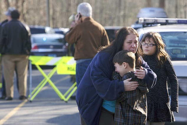 First-grader Henry Terifay and his sister, fourth-grader Kelly Terifay, are comforted outside the Sandy Hook Elementary School after a shooting in Newtown, Connecticut, December 14, 2012. A shooter opened fire at the school. REUTERS/Michelle McLoughlin (UNITED STATES - Tags: CRIME LAW EDUCATION TPX IMAGES OF THE DAY) - RTR3BKQF