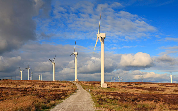 Two walkers at Ovenden Moor Wind Farm Ovenden Halifax West Yorkshire England UK