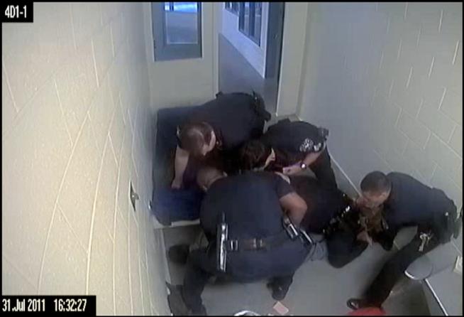 Screen grab from a video showing Denver sheriff's Deputy Edward Keller and other officers violently subduing inmate Jamal Hunter, recorded in the summer of 2011.