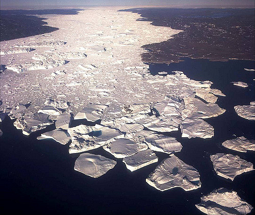 Icebergs spilling out of Jakobshavn Fiord from the Greenland Ice Sheet, seen on the horizon. (Photo courtesy of Oregon State University)