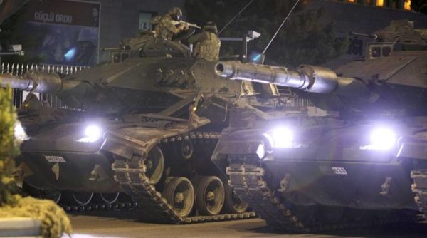 A military aims his weapon on top of a tank during an attempted coup in Ankara