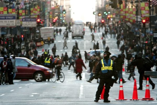 An NYPD officer blocks traffic along Fifth Avenue which is closed except for essential vehicle traffic in New York